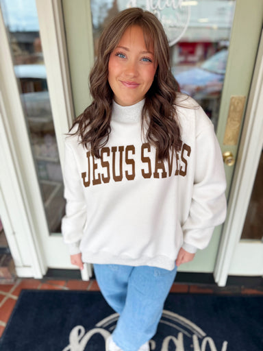 Reversible sweatshirt with Jesus Saves on one side and a cross on the other 