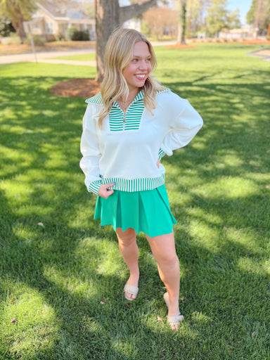 Quarter zip with green and white stripe trim detailing